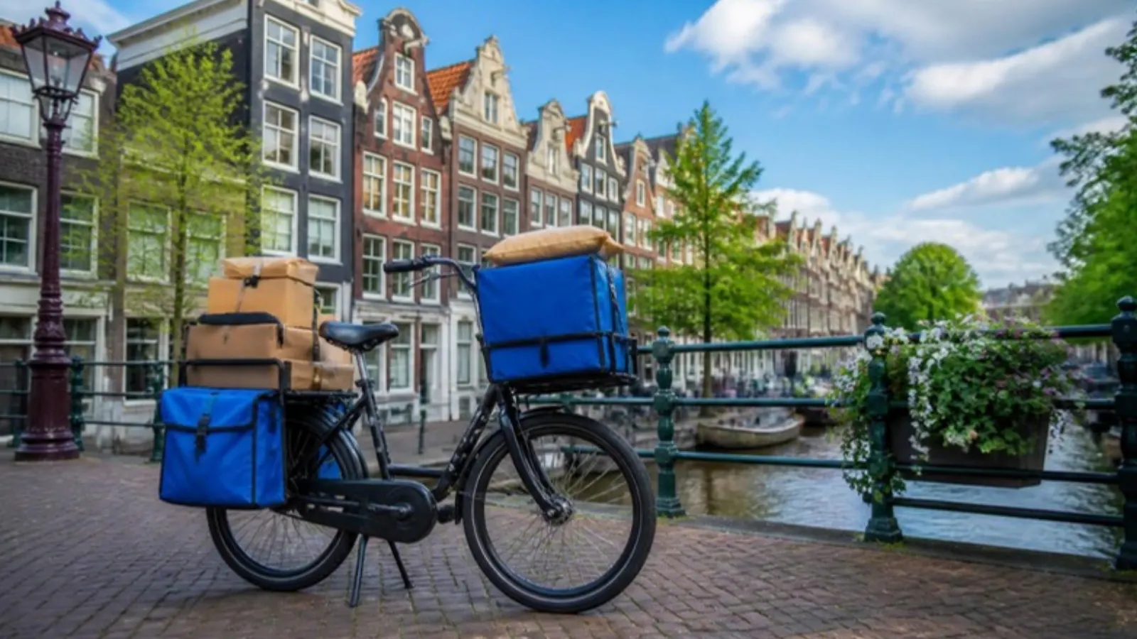 Delivery bike with parcels beside an Amsterdam canal